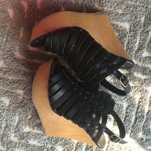 Black faux leather wedges