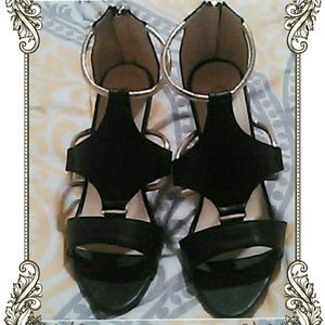 Black with gold straps shoes.