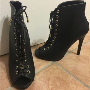 Black laces up bootie style heels