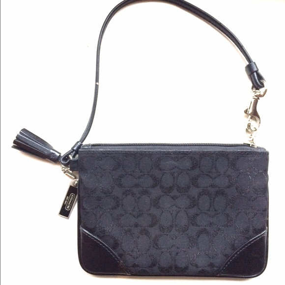 Coach wristlet with neon pink lining.