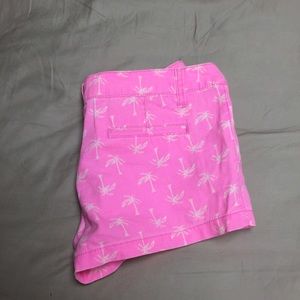 Bright pink shorts with palm trees