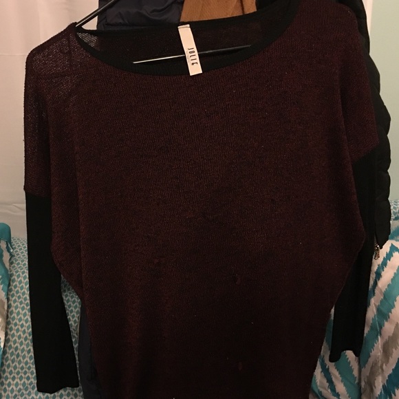 A maroon, black sleeve dress shirt.