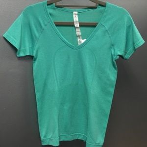 Lululemon tshirt w/Omega logo. Size 4.