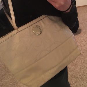 Medium sized, off-white Coach handbag