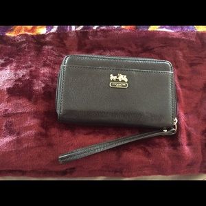 Coach Leather wallet with hand strap.
