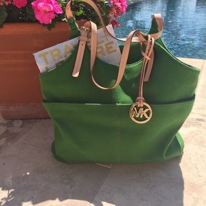 Michael Kors green canvas tote with outer pockets.