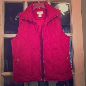 Red puffer vest with gold accent.