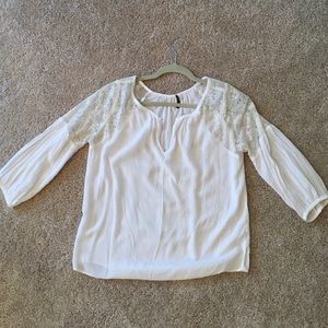 White lace-detailed blouse.