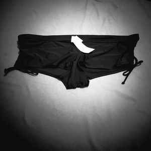Black bikini bottoms with cinch ties on the sides