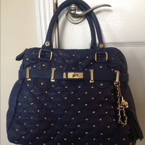 Gold studded blue Steve Madden bag.