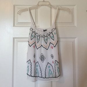 White tank top with multi color design.