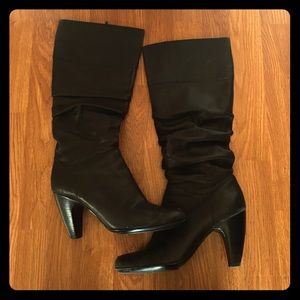 Black leather heeled boots.