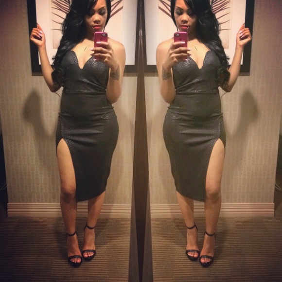 Black snake skin dress with high split .