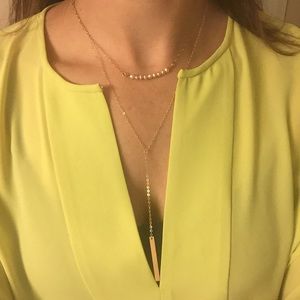 Long necklace with gold filled chain and tag.