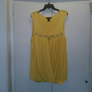 Yellow sleeveless shirt with  design at top