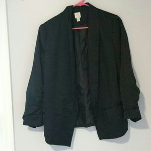 A polyester three quarter sleeve black blazer.