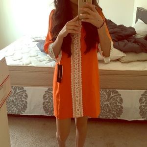 Very cute loose orange dress with lace.