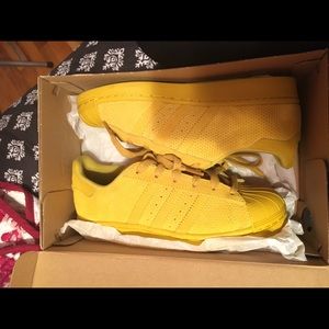 Mustard color adidas superstar shoes