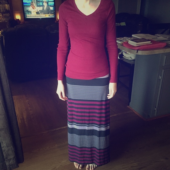 Deep maroon, knit V-neck shirt.