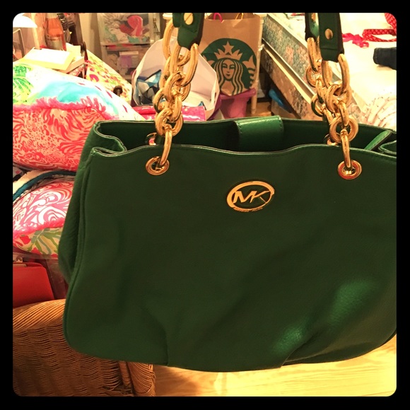 Michael Kors green purse with gold chain handles.