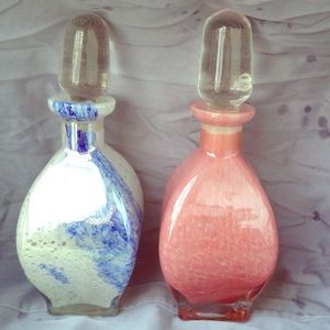 Two beautiful glass perfume bottles.