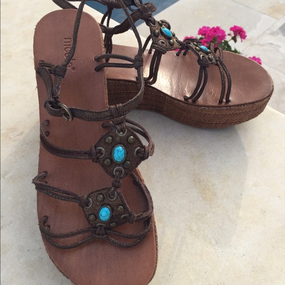 Platform sandals with turquoise stones.