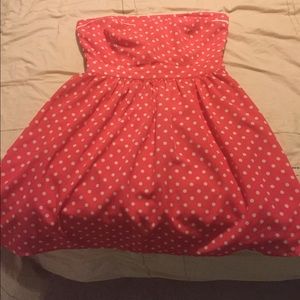 Coral polka dot strapless dress.