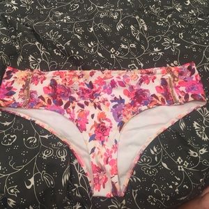 Floral bathing suit bottoms with rose gold zippers