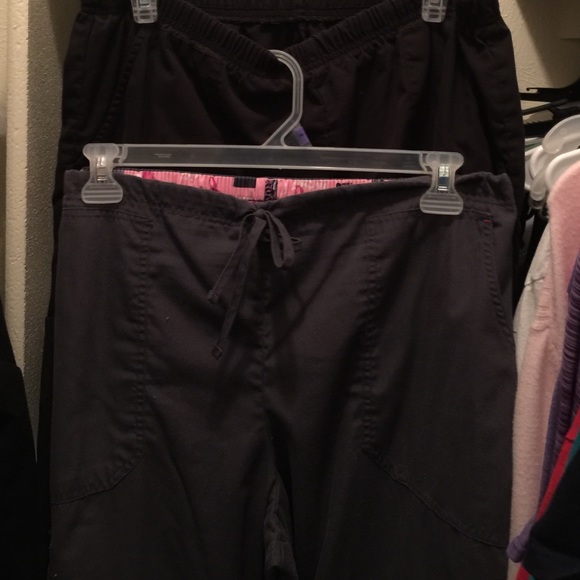 Four scrub tops and two scrub bottoms