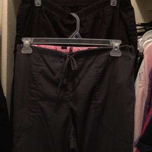 Four scrub tops and two scrub bottoms