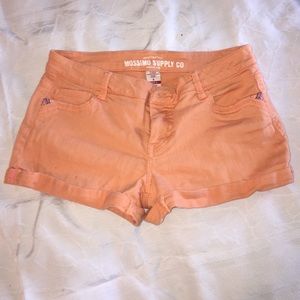 Peach colored shorts with multicolored pockets