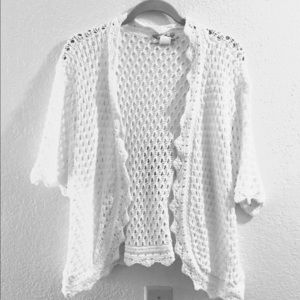 Short white crocheted shrug/sweater.