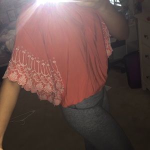 Reddish orange dolman sleeve top.