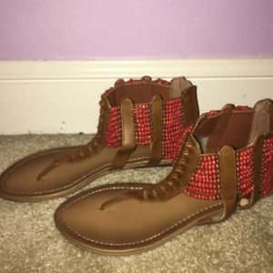 Brown thong sandals with orange bead accents