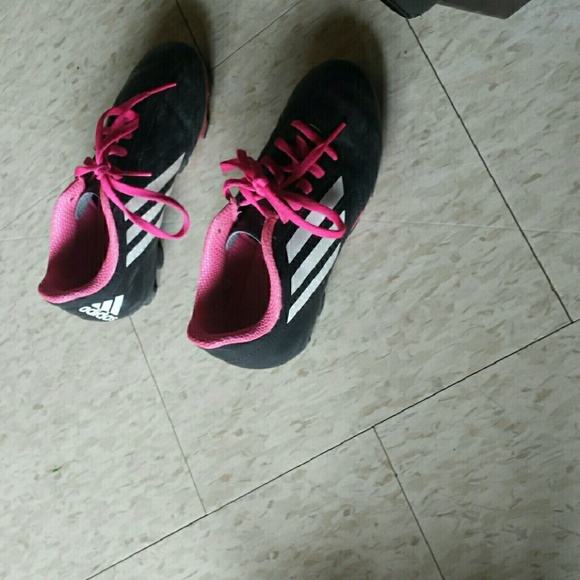 Three pairs of shoes one pair of cleats