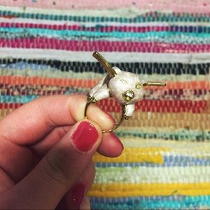 A gold flying pig ring