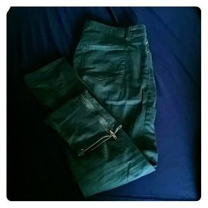 Green skinny jeans with zippers on the ankles