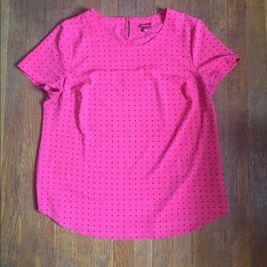 Pink blouse with polka dots.