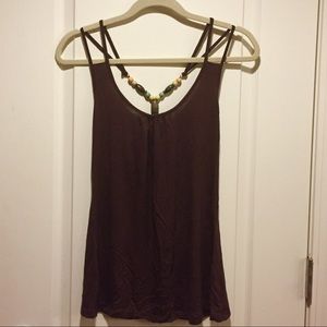 A brown tank top with double straps and beads.