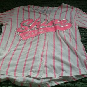 A pink baseball style Justice top