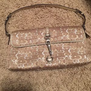 Champagne color Coach wristlet
