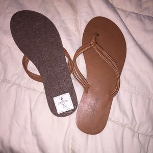 Tan flip flops