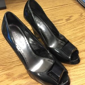 Black BCBG peep toe patent leather heels.