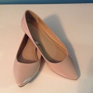 Pointed toe nude flats.