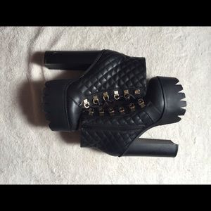Black high platform boots with gold hardware