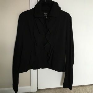 Black fashion jacket with ruffle detail.