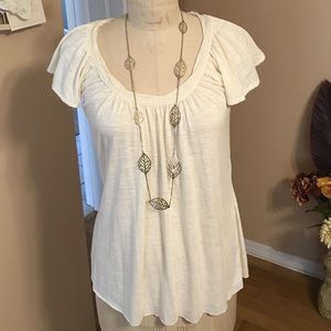 Never worn. Cream colored top with flutter sleeve