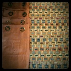 Rust grommet curtains and small colorful rug