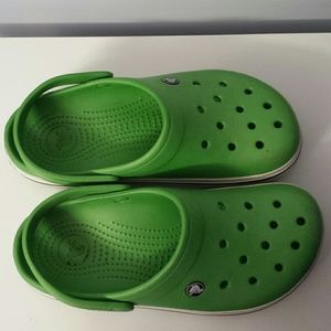 A green pair of 9 women's Crocs.