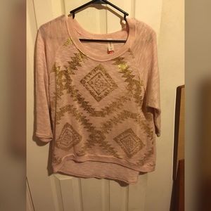 Light pink sweater with gold foil design. Hi-lo